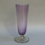 A purple glass vase with internal bubble decoration on clear glass stem and circular foot,