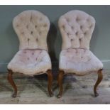 A pair of Victorian walnut salon chairs with pale pink velvet buttoned backs and stuffed over