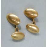 An Edward VII pair of cufflinks in 15ct gold, each plain oval domed face joined by trace links,