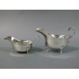 Two George III style sauceboats, one with flying capped handle on shell cast cabriole leg with feet,