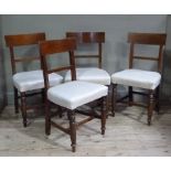 A set of four post Regency mahogany dining chairs with concave backs,