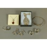 A collection of silver jewellery including a pair of silver and garnet set cufflinks in the form of