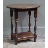 An oak two tier occasional table the oval top above turned supports joined by plain undertier,