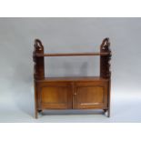 A late 19th century mahogany wall shelf with pierced side brackets and two door cupboard