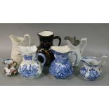 Seven various Victorian and later jugs including Mason's ironstone type with serpent handle,