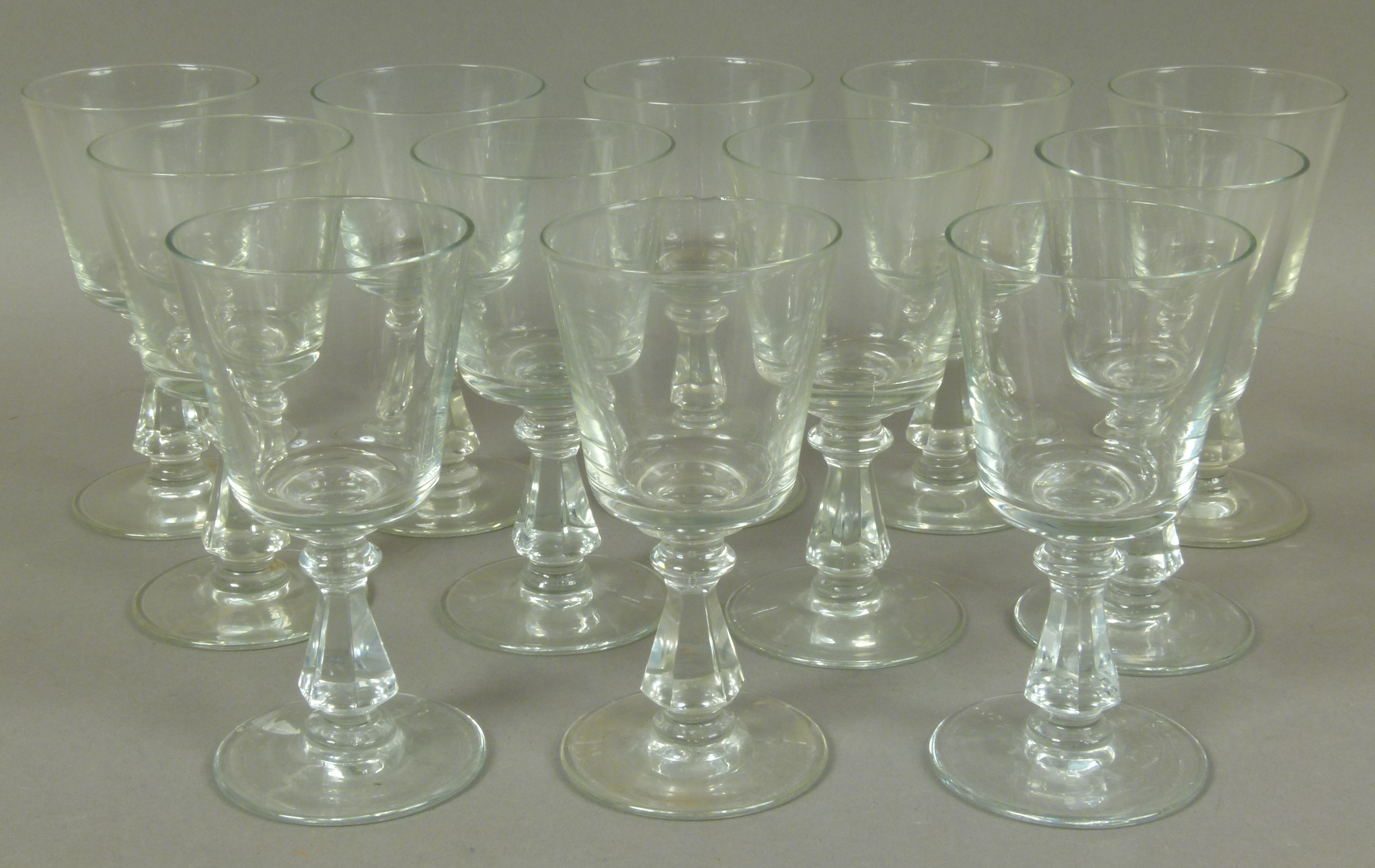 A set of twelve 19th century glass wines, plain bucket bowl on a knopped and faceted stem,