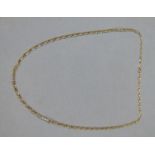 A neckchain in figaro links of yellow metal (tests as 9ct gold) approximate length 59cm,