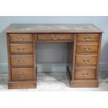 A mahogany twin pedestal desk with inset gilt tooled green leather sciver,