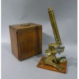 A lacquered brass microscope contained in a fitted mahogany box containing drawer with slides,