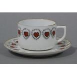 A continental porcelain teacup and saucer printed and painted with love hearts within roundel
