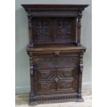 A Victorian Jacobean Revival cupboard with flared cornice above Taurus fluted frieze flanked by a