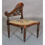 A mid Victorian simulated rosewood music chair, having pierced and swept back,