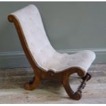 A Victorian walnut nursing chair with buttoned peach coloured dralon upholstery,