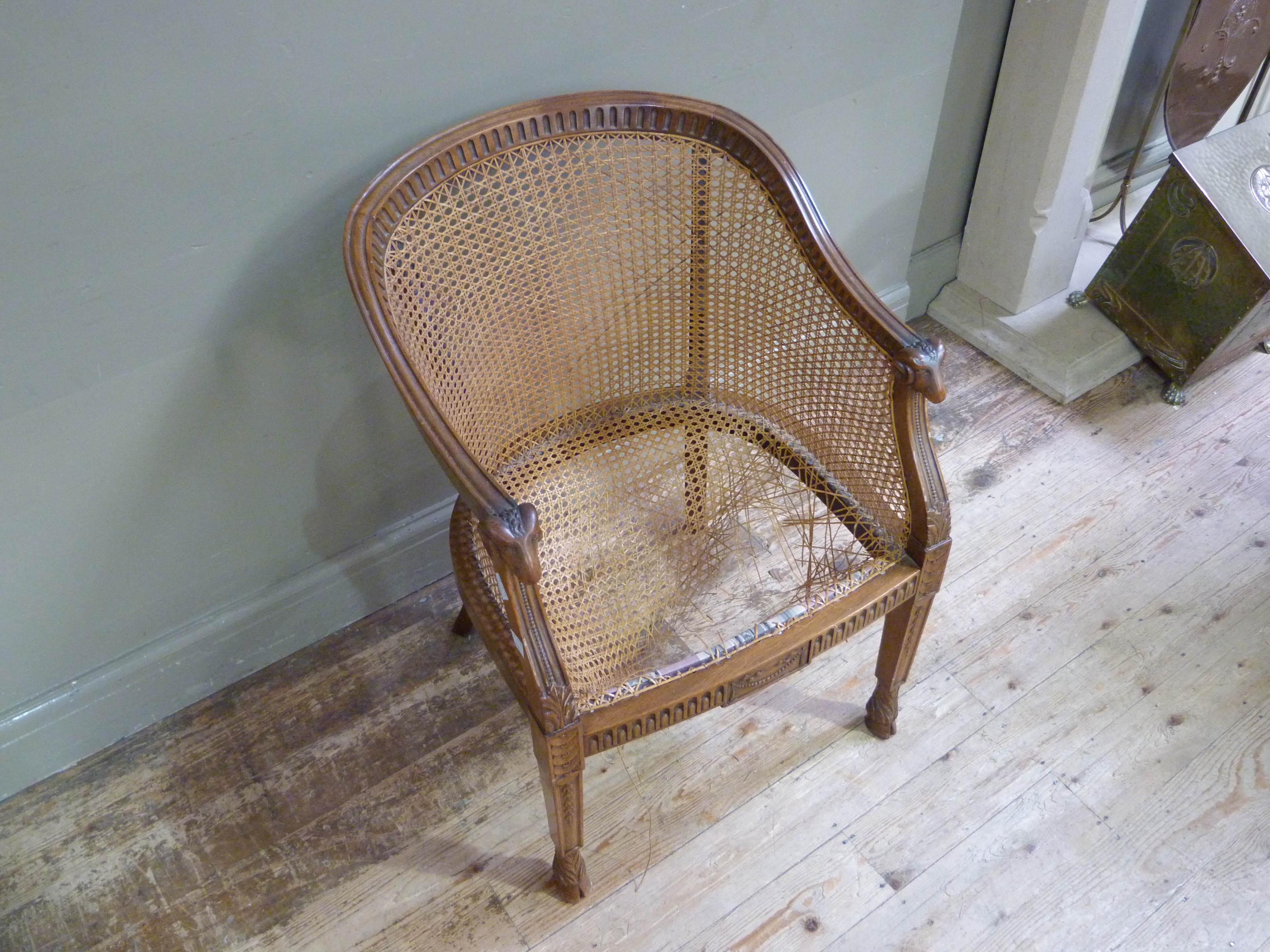 An Edwardian mahogany and bergere caned tub chair the arms with ram mask terminals, - Image 2 of 2