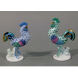 A pair of Herend porcelain models of cockerels one mainly in blue palette the other in green,