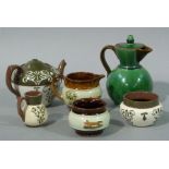 A Watcombe green glazed jug with brown strap handle,
