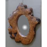 A burr trunk segment with oval aperture fitted with mirror plate,
