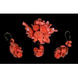 A Victorian coral demi parure the brooch and ear pendants each carved as a cluster of flower heads
