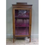 An Edwardian inlaid mahogany display cabinet with shaped back, the frieze line inlaid,