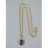 An amethyst pendant and chain in 9ct gold,