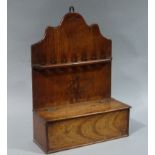 A George III mahogany pipe rack, shaped back, provision for pipes and lidded base,