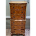 A reproduction burr walnut veneered tallboy of serpentine outline,