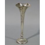 An Edward VII trumpet shaped spill vase embossed with scrolls, shells and leafage,
