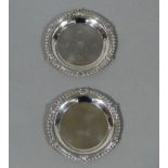 Two similar George III style miniature circular dishes with leaf cast gadrooned rims, 9cm diameter,