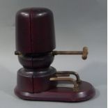 A reproduction mahogany stained wooden hat stretcher,