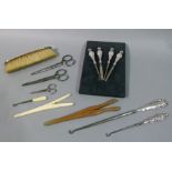 A silver handled manicure set, silver handled button hooks (2), silver handled brush,