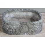 A concrete rounded rectangular garden planter,