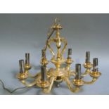 A brass eight branch chandelier with baluster and open column approximately 90cm drop from rose to