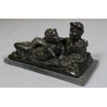 A 19the century black painted bronze group, of two reclining classical male and female figures,