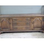 A reproduction oak dresser base the rectangular top with moulded lip above three raised fielded