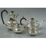 A George III style panelled boat shaped four piece silver tea service, ebonised fitting by Viners,