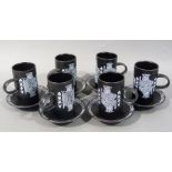 A Purbeck pottery coffee service transfer printed with picture cards in white on a black ground,