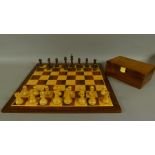 A modern wooden chess set and pieces,