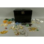 A black tin box containing a collection of late 20th century costume jewellery including, necklace,