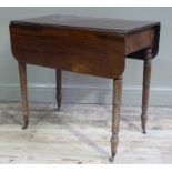A George IV mahogany small Pembroke table with pair of drop flaps on ring turned legs fitted with