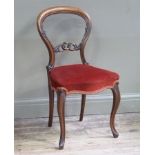 A Victorian walnut dining chair with kidney shaped back and foliate pierced carved horizontal rail,