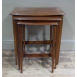 A nest of three Edwardian quarter veneered tables of bowed form,