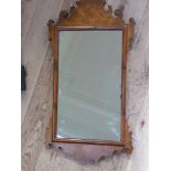 A figured walnut veneered wall mirror with fret cut frame 68.