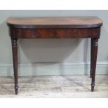 A George III mahogany tea table the figured top with reeded lip above a figured frieze on fluted