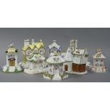 A collection of nine Coalport cottage orneés comprising, the oast house, twin towers, dove cote,