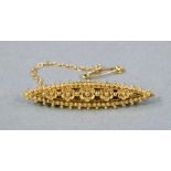 Bar brooch in 15ct gold, marquise outline with applied bead and foliate decoration,