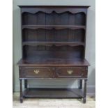 An oak dresser in early 18th century style with flared cornice, shaped apron,