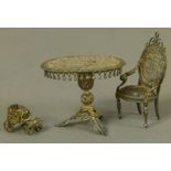 A good continental silver filigree miniature table and chair in the 'French taste',