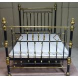 A Victorian brass and black lacquered double bed stead with stylised thistle shaped finials,