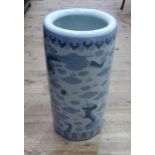 A Chinese porcelain cylindrical stick stand decorated with stylised dragons and clouds,