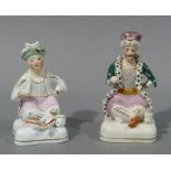 A pair of Staffordshire figures of sultan and companion both seated cross legged on cushion 'bases',